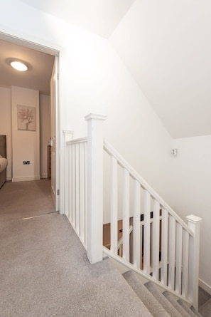 A staircase with white railings leading to a landing. - Beautiful two Bedroom Family Home With Pool Table Durham (Durham)