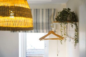 A room with a hanging wooden hanger, a striped window valance, and a hanging plant. - Modern Coastal Stay Minutes From Redcar Beach (Redcar)