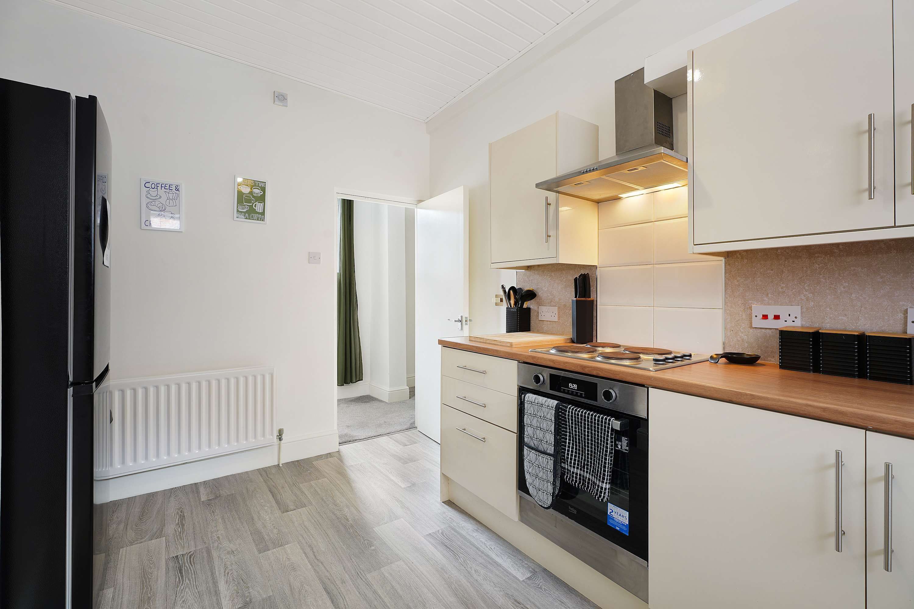 A modern kitchen with a refrigerator, stove, oven, and cabinets.