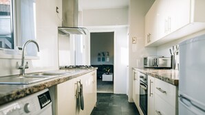 A modern kitchen with a built-in dishwasher, a stove, and a microwave. - Freda House Horizon Stays (Sunderland)