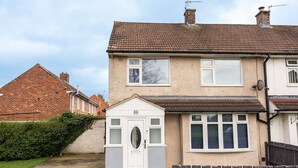 A two-story residential building with a small attached garage. - Renvyle House Horizon Stays (Stockton-on-Tees)