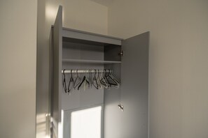 A grey wardrobe with a hanging rod for clothes. - Pottery Wharf Horizon Stays (Stockton-on-Tees)