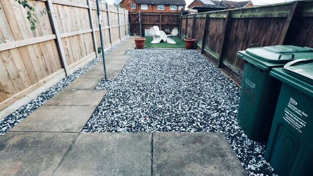 A backyard with a gravel path, a wooden fence, and a green trash bin. - Thornwood House Horizon Stays (Stockton-on-Tees)