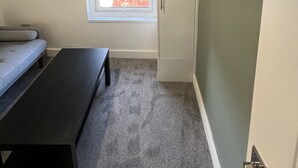 A room with a bed, a desk, a wardrobe, and a window with a view. - Romney House Central Middlesbrough (Middlesbrough)