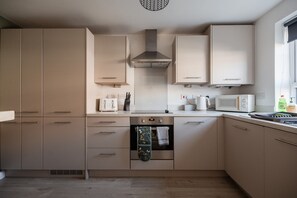 A modern kitchen with built-in appliances, including a microwave, toaster, and oven. - The Norton Nook Horizon Stays (Stockton-on-Tees)