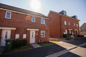 A residential street with brick houses, a clear sky, and a visible rainbow. - The Norton Nook Horizon Stays (Stockton-on-Tees)