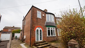 A two-story brick house with a curved bay window and a front door with an arch. - Humber House Thornaby (Stockton-on-Tees)