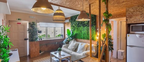 A modern interior with a sofa, coffee table, and hanging lights.