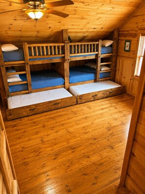 A wooden cabin with bunk beds, a ceiling fan, and a window with blinds. - "Starlake" A huge waterfront 5 bedroom estate only 15min to downtown Blueridge. (Mineral Bluff)
