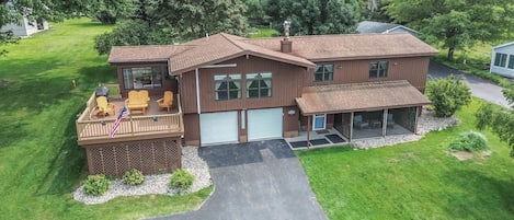 A two-story house with a covered porch, a garage, and a landscaped yard.