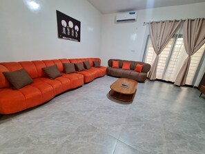 A living room with a sectional sofa, a smaller sofa, and a coffee table. - Luxury Villa in Ngaparou: 4 bedrooms, 5 bathrooms, pool, Wi-Fi, pool house (Ngaparou)