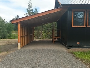 A covered outdoor area with a gravel path leading to a building with a metal roof. - Gateway to the North: Legendary Rivers, Epic Trails & 180 Acres to Yourself (Hazleton)