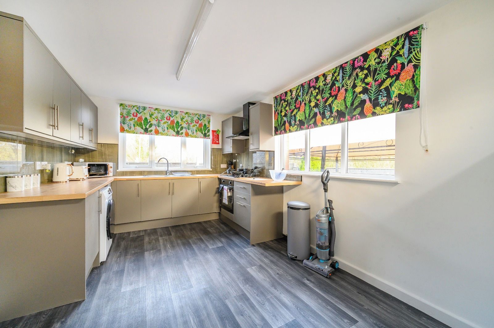 A modern kitchen with a microwave, toaster, and sink.
