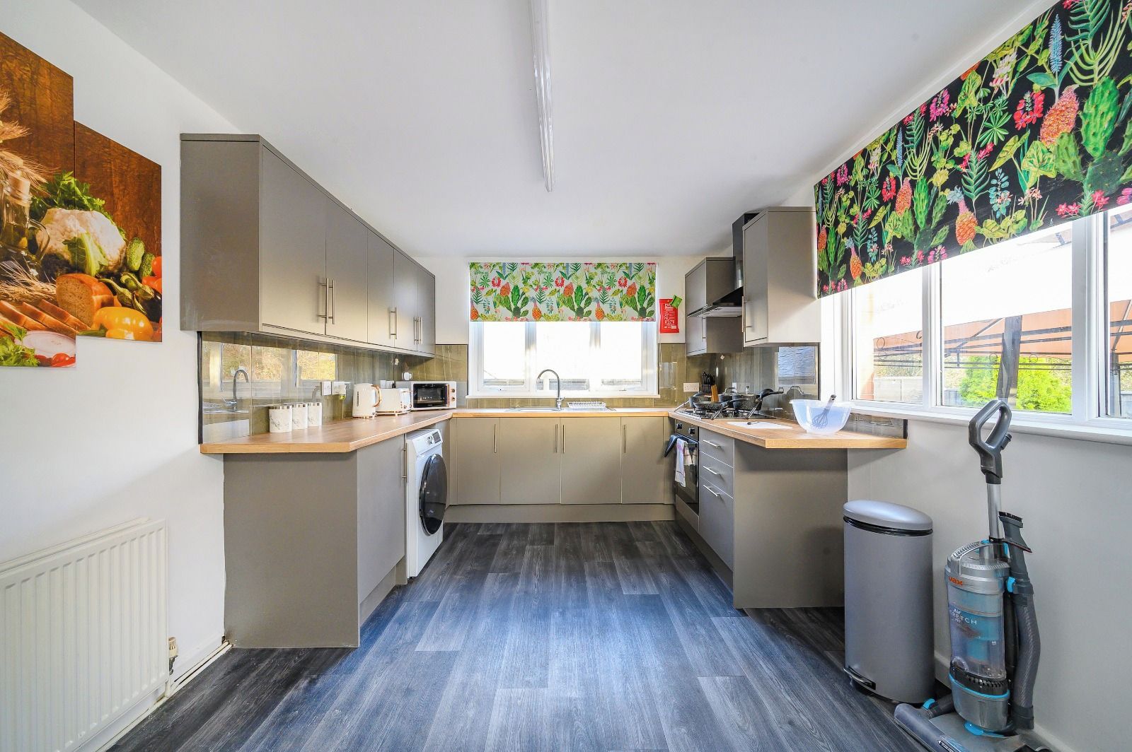 A compact kitchen with a washing machine, a microwave, and a sink.