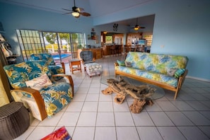 A spacious living area with a sofa, chairs, and a coffee table. - The Buck Island Overlook | Sleeps 12 (Christiansted)