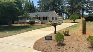 A single-story house with a front porch, a mailbox, and a 'PRIVATE RESIDENCE' sign.