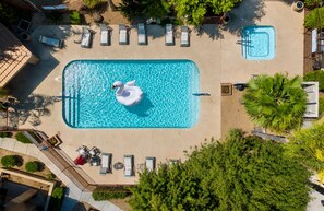 An aerial view of a swimming pool with a swan float, surrounded by lounge chairs and a smaller pool. - Modern Villa+ Scottsdale Resort + Pool + Golf Course+ Walking paths +Gym +Dining (Scottsdale)