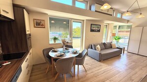 A modern interior with a dining area, sofa, and large windows. - Penthouse with a Panorama balcony, and free Parking! (Kecskemét)