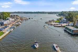 A marina with boats docked, a dockside building, and a clear view of the water. - Timber & Tide: Two-Space Woodland Retreat (Saugatuck)