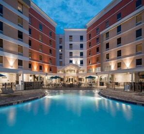 Ein Hotel mit einem zentral gelegenen Schwimmbad, mehreren Etagen und Außenbereichen zum Verweilen.
