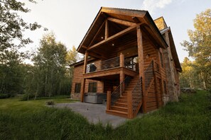 A wooden cabin with a balcony, a staircase, and a hot tub. - Parkside Teton Springs Cabin in Victor, ID w/ A/C & Hot Tub (Victor)