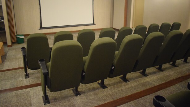 A conference room with rows of chairs facing a blank projection screen. - Santa Marta: Sunset View, Pools, and Private Beach in Pozos Colorados (Santa Marta)
