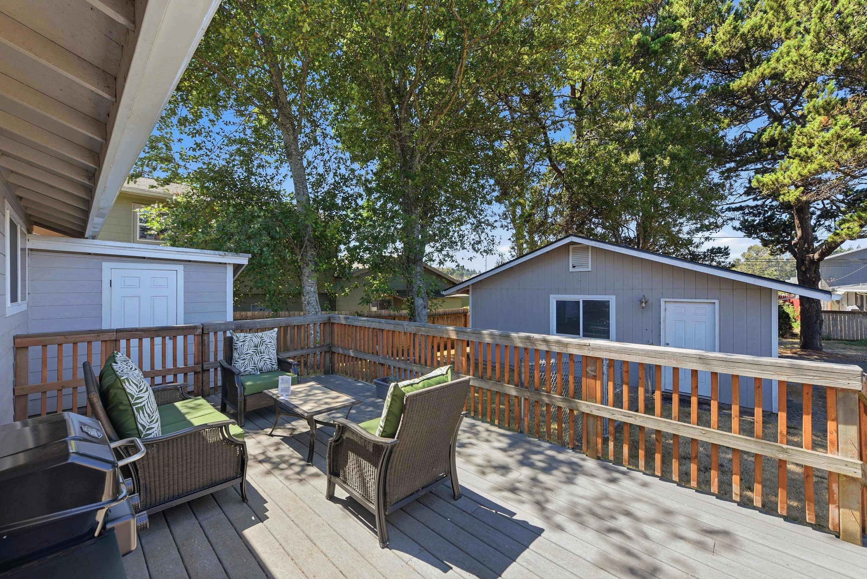 A deck with outdoor furniture and a wooden fence.