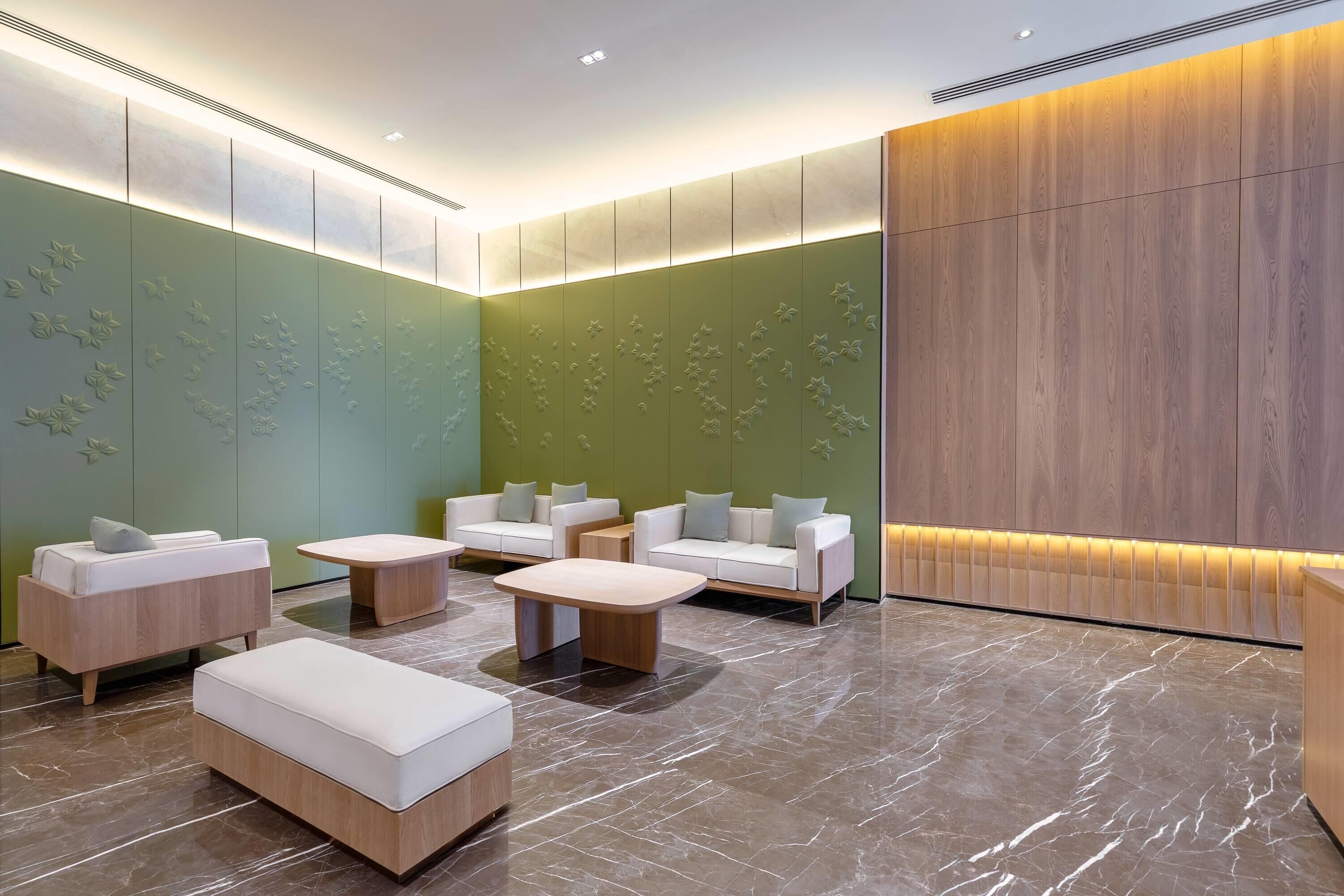 A modern lounge area with seating and a reception desk.