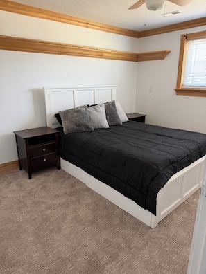 A bedroom with a bed, nightstands, and a window. - Peaceful 2-bedroom with Renovated Kitchen in fantastic Orem location (Orem)