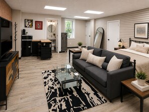 A modern living room with a sofa, coffee table, and a TV.