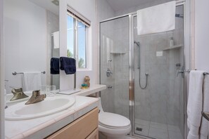 A modern bathroom with a glass-enclosed shower, a white sink, and a toilet. - The Lookout Palm Springs | Stunning Views (Palm Springs)