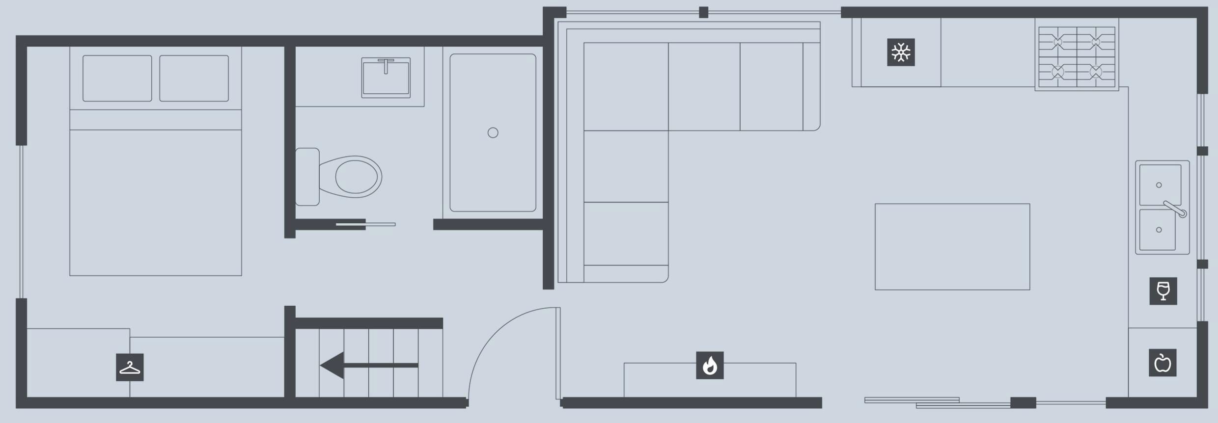 Un plan d’étage d’hôtel comprenant une cuisine, un coin repas et une salle de bain.