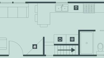 A hotel floor plan with a kitchen, dining area, and a bathroom.