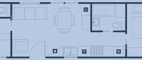 Plano de planta de un hotel con zona de comedor, cocina y una habitación con cama y baño.