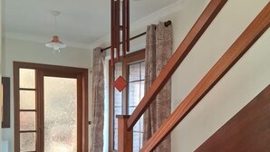 A wooden staircase leading to a room with a door that has frosted glass panels. - The Hollies (Walmer)
