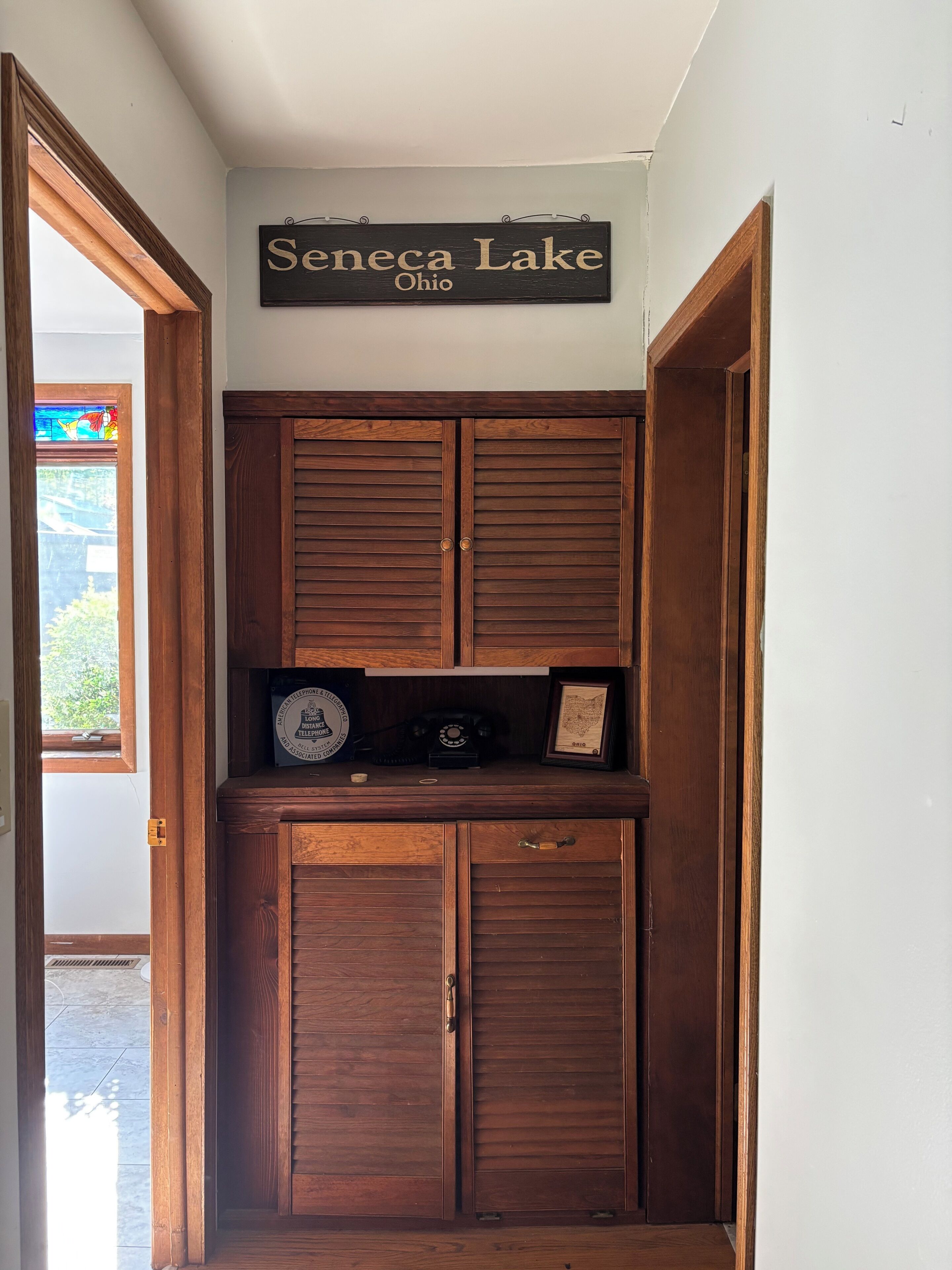A wooden cabinet with a sign above it reading 'Seneca Lake Ohio'.