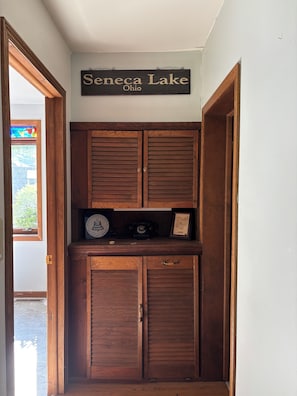 A wooden cabinet with a sign above it reading 'Seneca Lake Ohio'.