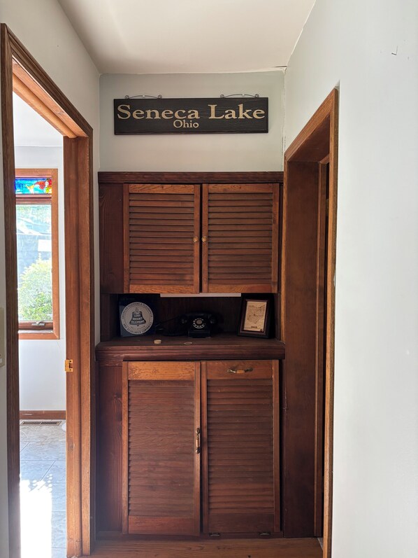 A wooden cabinet with a sign above it reading 'Seneca Lake Ohio'.