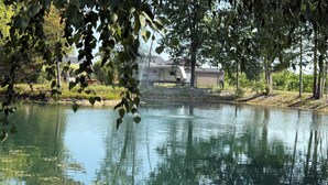 A calm body of water with reflections of trees and a building in the background. - After beaten path.
Camper with great amenities (Lakeshore)