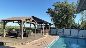 A pool area with a wooden deck, outdoor seating, and a hot tub. - After beaten path.
Camper with great amenities (Lakeshore)