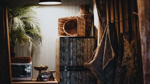 A kitchen with a microwave, a scale, a woven basket, a vase, and a hanging plant. - The Gums 40 wonderfully private country escape (Korweinguboora)