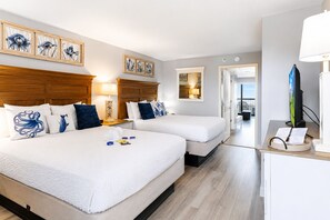 A hotel room with two beds, a desk with a computer, and artwork on the walls. - Sleeps 6 - Oceanfront Condo. Private Balcony. Beach Access, Pools & Lazy Rivers. (Myrtle Beach)