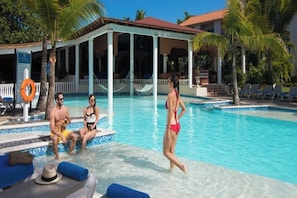 A pool area with lounge chairs, a covered seating area, and a lifebuoy. - Charming house in delightful Puerto Plata perfect for your getaway (Puerto Plata)