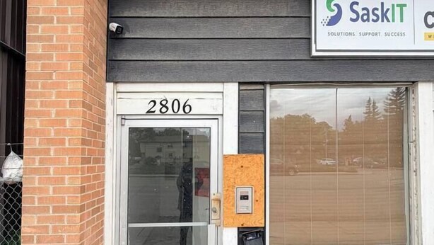 Un edificio con puerta de vidrio de entrada identificada con el número '2806' y un cartel que dice 'SaskIT Solutions Support Success'.