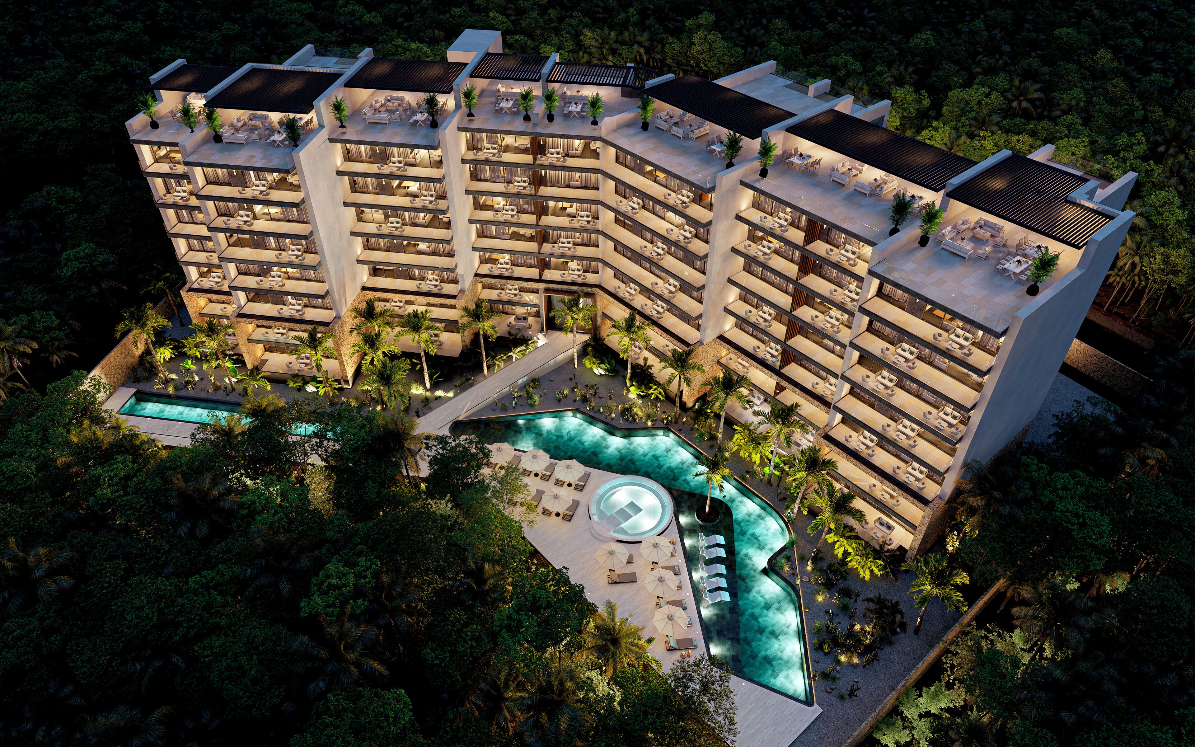 Un hôtel à plusieurs étages doté d’espaces de détente en plein air et d’une piscine.