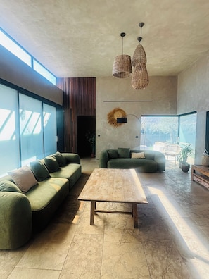 A modern living room with a sectional sofa, a coffee table, and a large window providing natural light. - Exceptional Villa, Arcachon Bay, Infinity Pool (Le Teich)