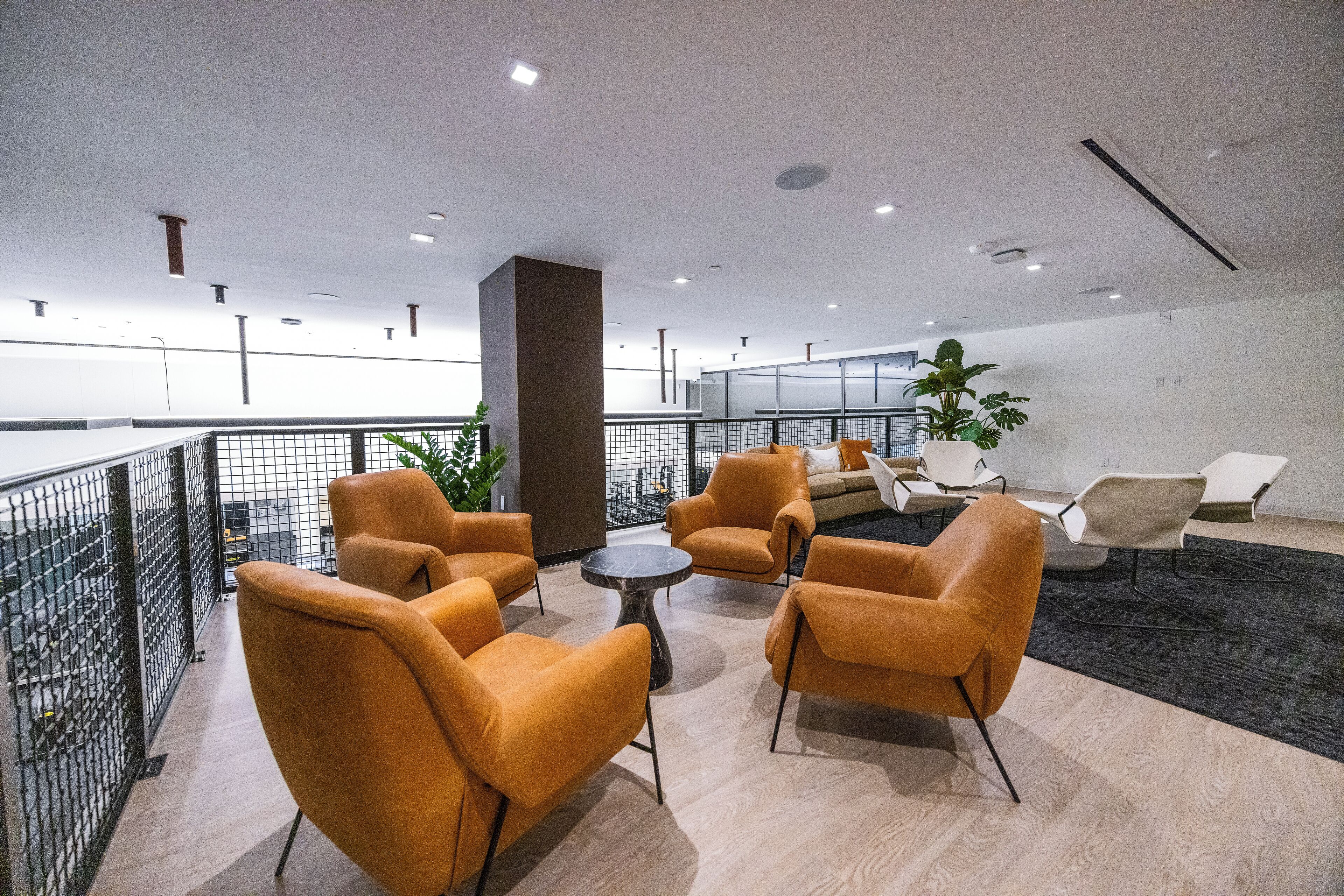 A modern lounge area with seating and a view of the city.