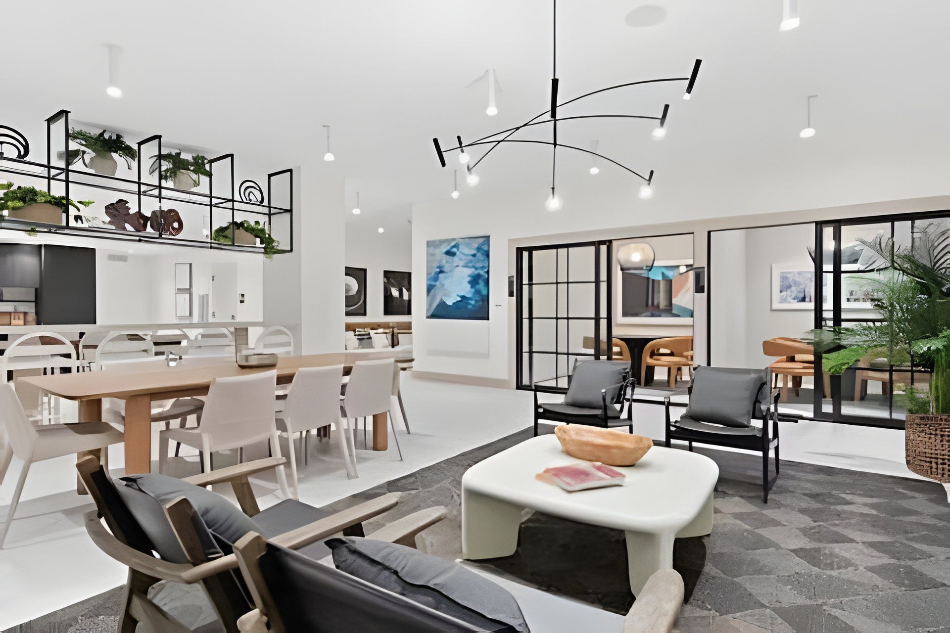 A modern interior with a dining area, seating, and a kitchen.