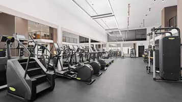 A gym with treadmills, ellipticals, and weight machines.