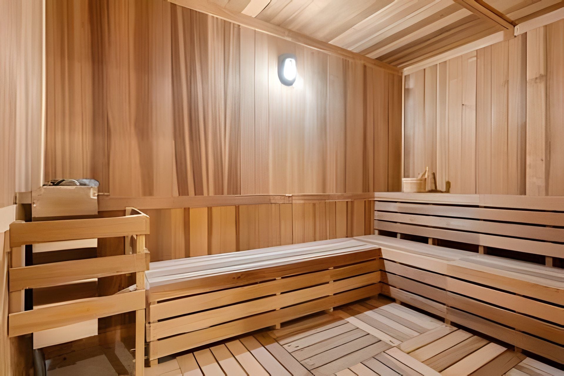 Un sauna avec des bancs en bois et un banc muni d’un porte-serviettes.